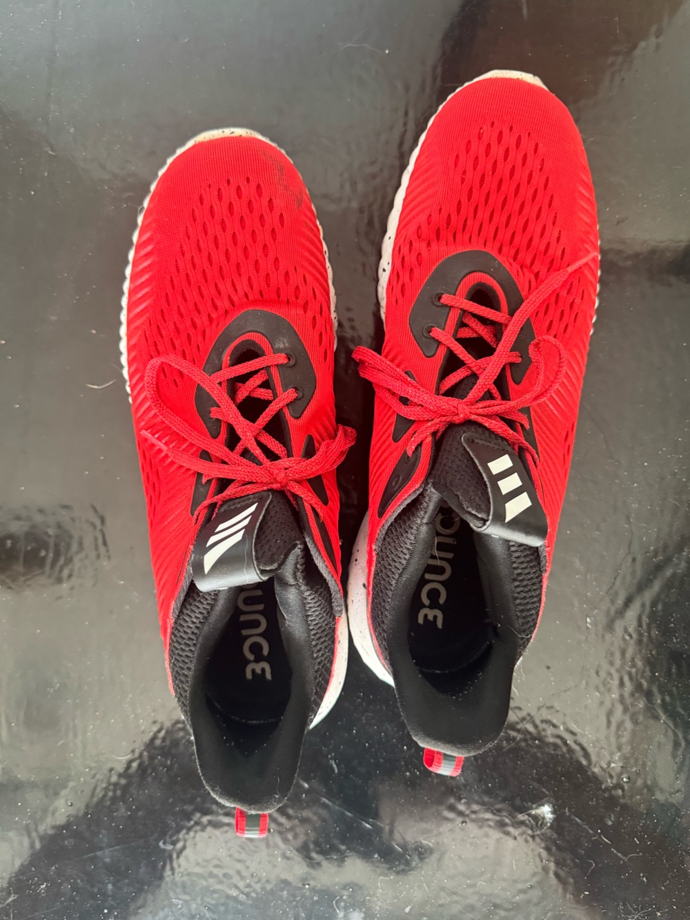 Adidas Alphabounce 1 sneakers in a vibrant red and core black colorway US 11